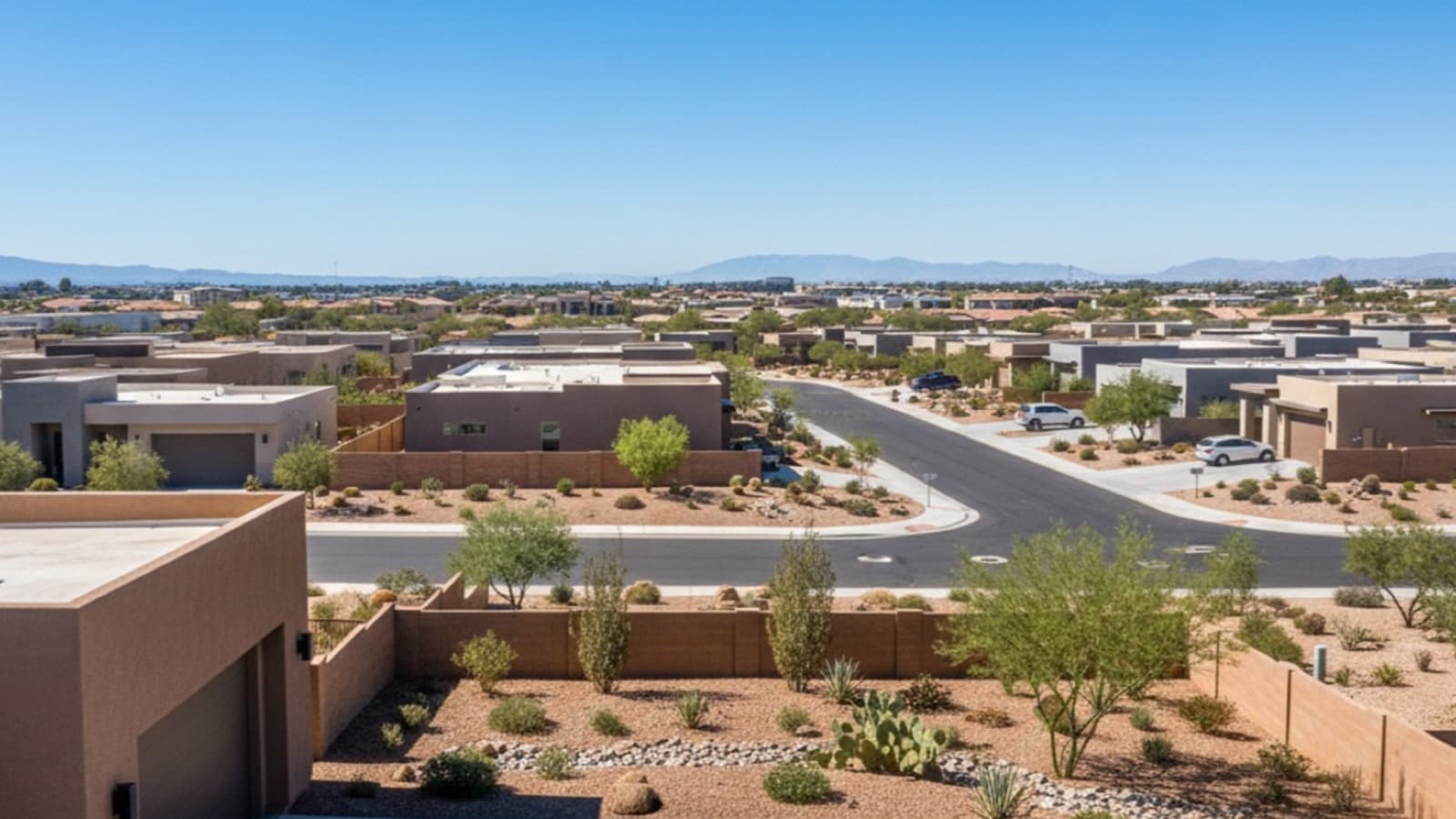 Las Vegas residential neighborhood at sunset with for-sale sign in front yard