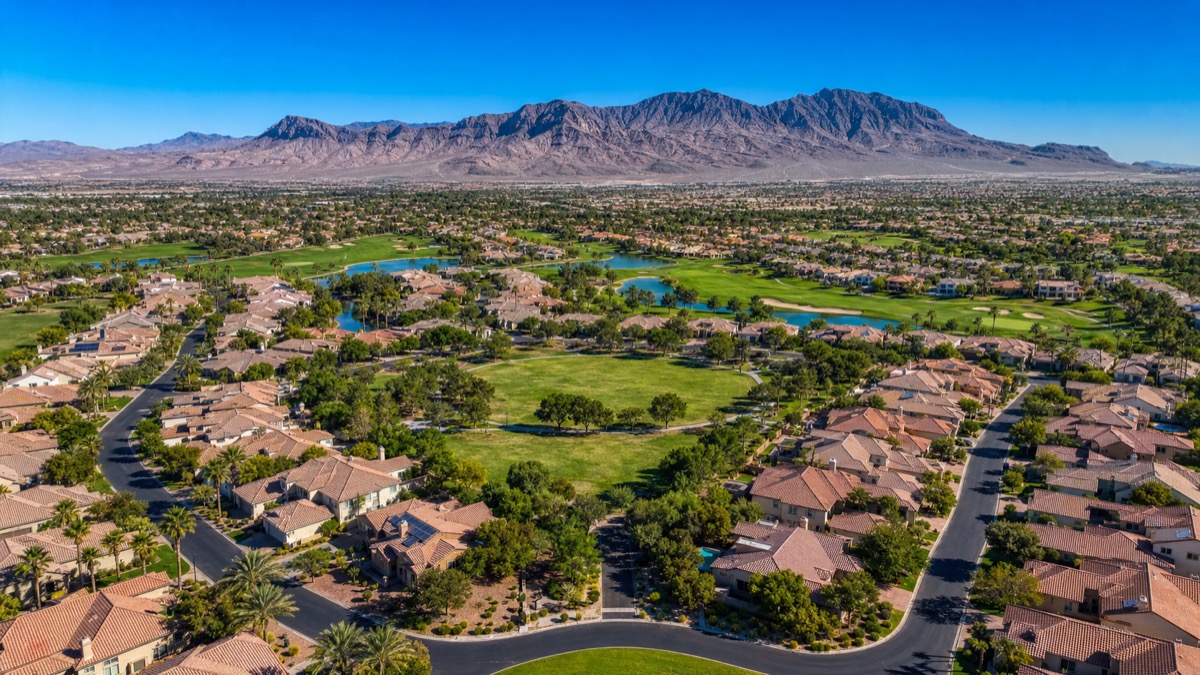 Single-family residential street in Aliante North Las Vegas showing larger lots and RV-friendly building setbacks typical of the 1990s and 2000s production homes that dominate this part of the valley