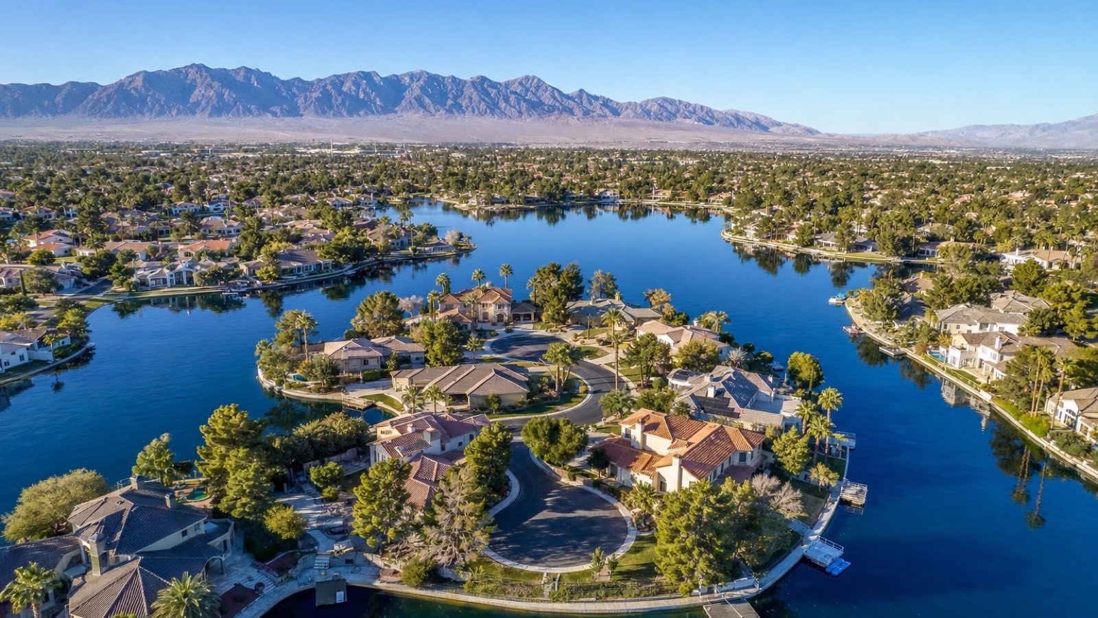 Desert Shores Las Vegas lakefront home with desert landscaping and artificial lake system in the northwest valley